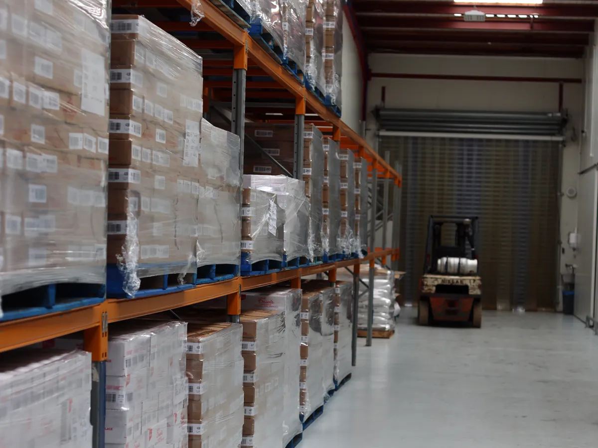 Pallets of finished product, shrink-wrapped on racking in the dispatch warehouse